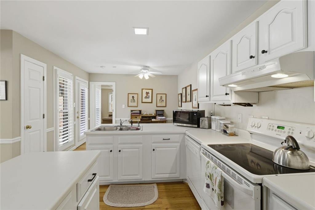 3269 Embry Downs Court Atlanta, GA 30340 - Photo 19 of 38 a kitchen with granite countertop a sink a stove and cabinets