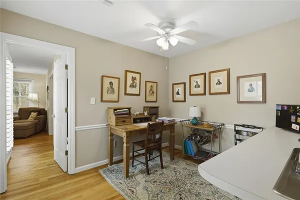 a view of a workspace with furniture and wooden floor