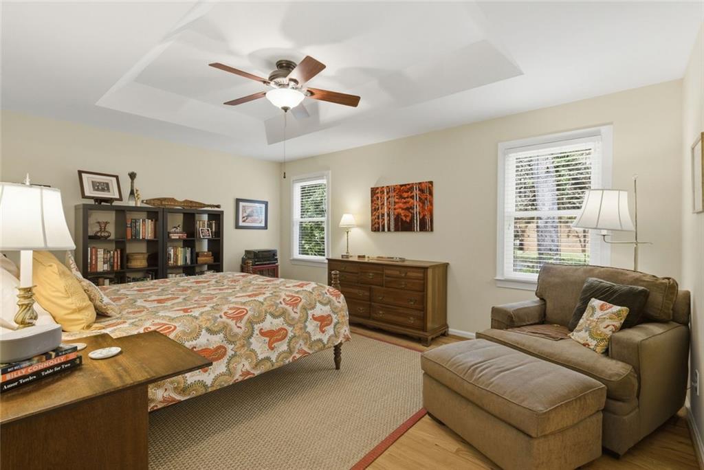 3269 Embry Downs Court Atlanta, GA 30340 - Photo 21 of 38 a bedroom with a large bed two couches and a flat tv screen