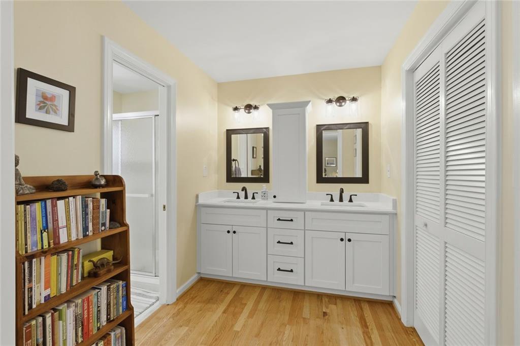 3269 Embry Downs Court Atlanta, GA 30340 - Photo 24 of 38 a spacious bathroom with a double vanity sink and a mirror