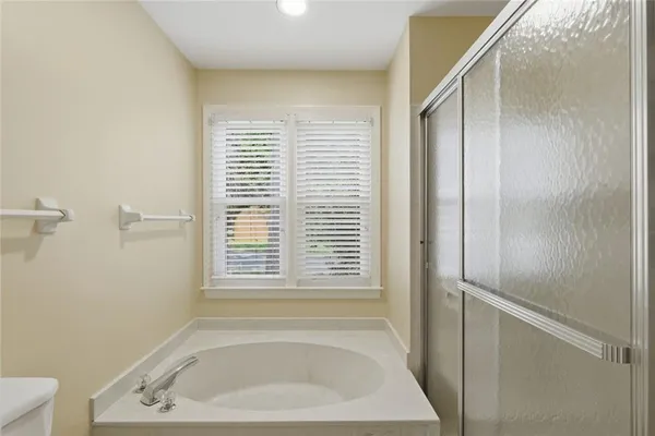 a bathroom with a bathtub and a window