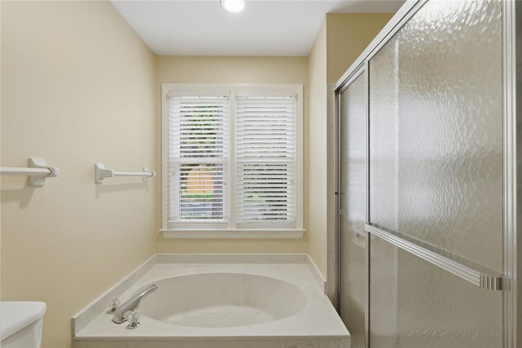 3269 Embry Downs Court Atlanta, GA 30340 - Photo 25 of 38 a bathroom with a bathtub and a window