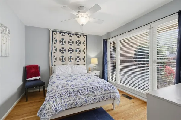 a bedroom with a bed dresser and a window