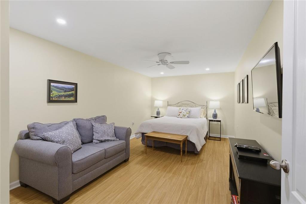 3269 Embry Downs Court Atlanta, GA 30340 - Photo 29 of 38 a bedroom with furniture and a wooden floor