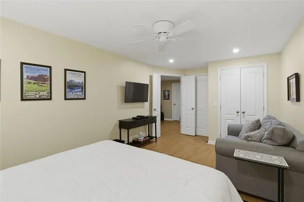 a bedroom with furniture and a flat screen tv
