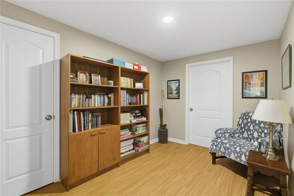 3269 Embry Downs Court Atlanta, GA 30340 - Photo 31 of 38 a bedroom with furniture and a book shelf