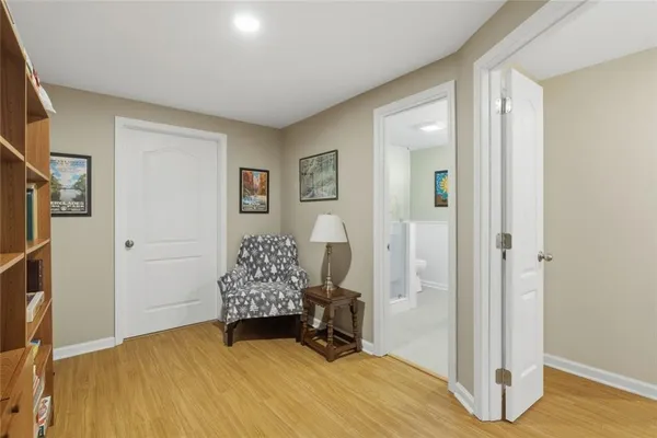 a view of bedroom with hardwood floor and hallway