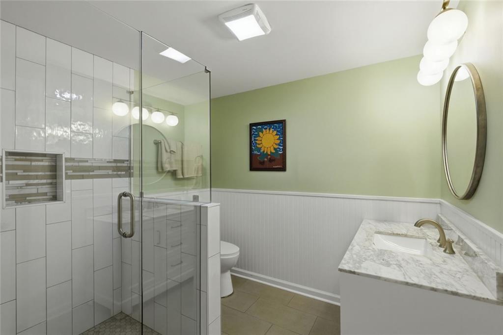 3269 Embry Downs Court Atlanta, GA 30340 - Photo 33 of 38 a bathroom with a granite countertop sink a mirror and shower
