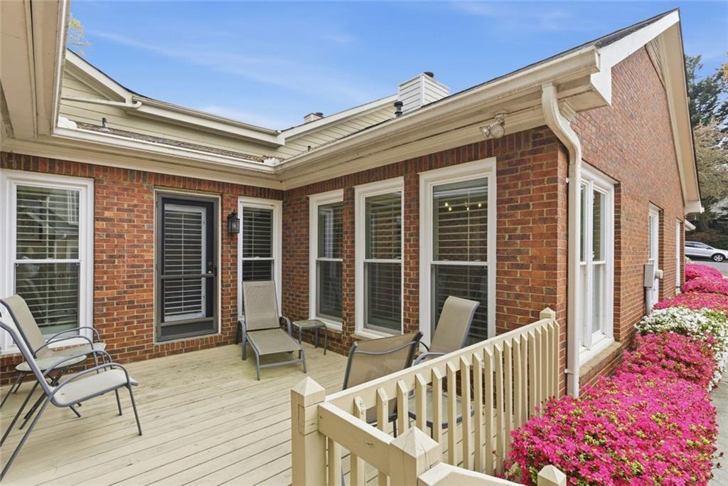 3269 Embry Downs Court Atlanta, GA 30340 - Photo 37 of 38 a view of a balcony with two chairs and wooden floor