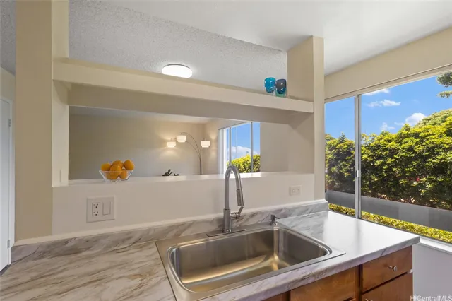 a kitchen with a sink and mirror