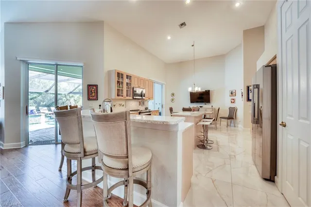 a kitchen with sink cabinets and living room view