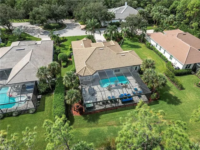 a view of a swimming pool with a table and chairs under an umbrella
