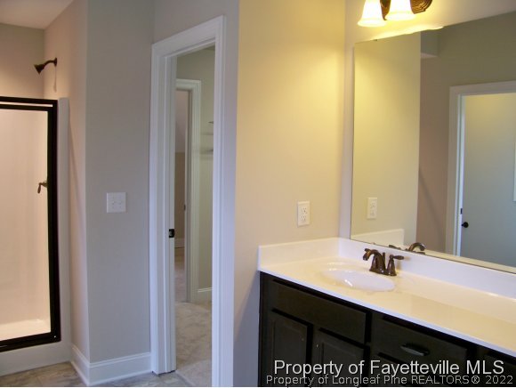 101 Caulfield Road Aberdeen, NC 28315 - Photo 13 of 19 a bathroom with a sink a mirror and a vanity