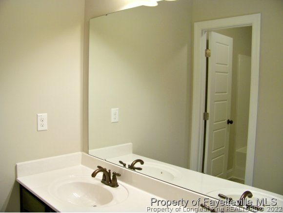 101 Caulfield Road Aberdeen, NC 28315 - Photo 15 of 19 a bathroom with a sink and a mirror