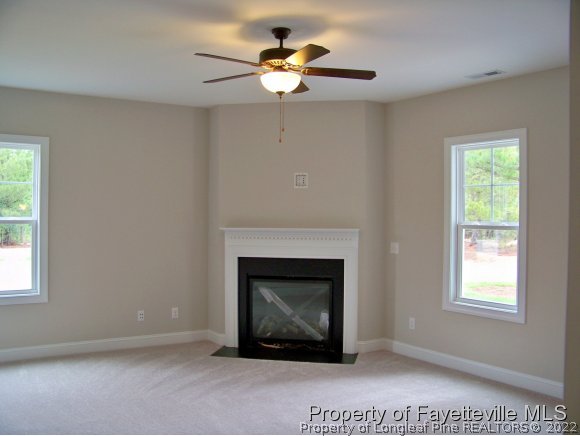 101 Caulfield Road Aberdeen, NC 28315 - Photo 5 of 19 a living room with furniture a fireplace and a window