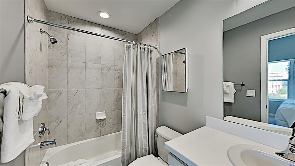 13101 Gulf Boulevard, Unit 1506 Madeira Beach, FL 33708 - Photo 11 of 15 a bathroom with a sink toilet and shower