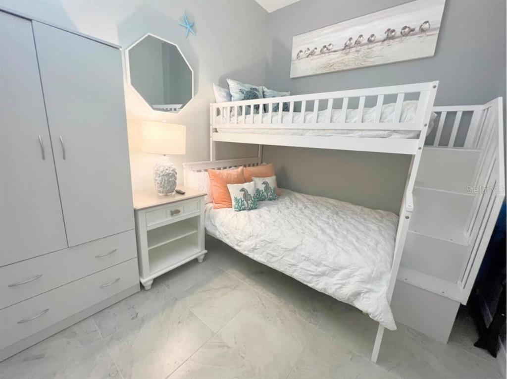 13101 Gulf Boulevard, Unit 1506 Madeira Beach, FL 33708 - Photo 13 of 15 a bedroom with a bed and a window