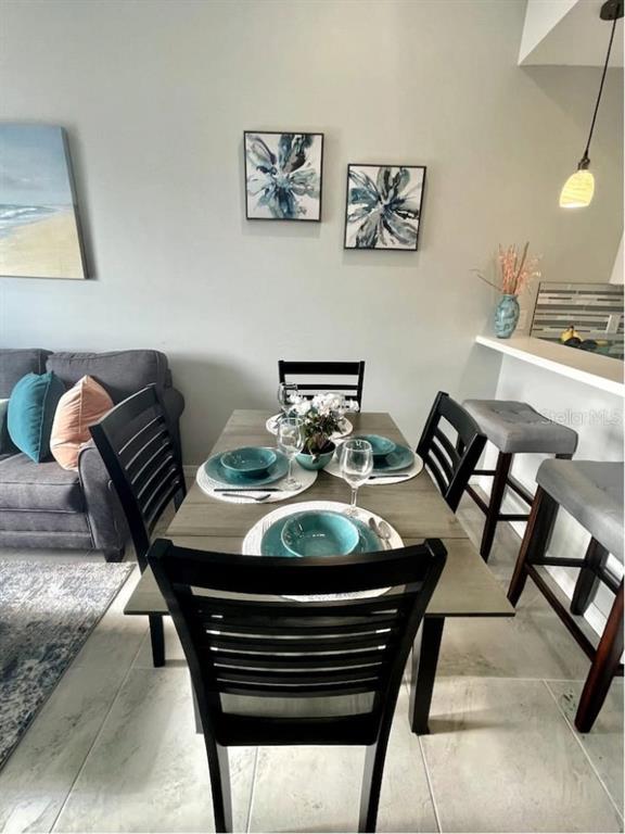 13101 Gulf Boulevard, Unit 1506 Madeira Beach, FL 33708 - Photo 7 of 15 a view of a dining room with furniture