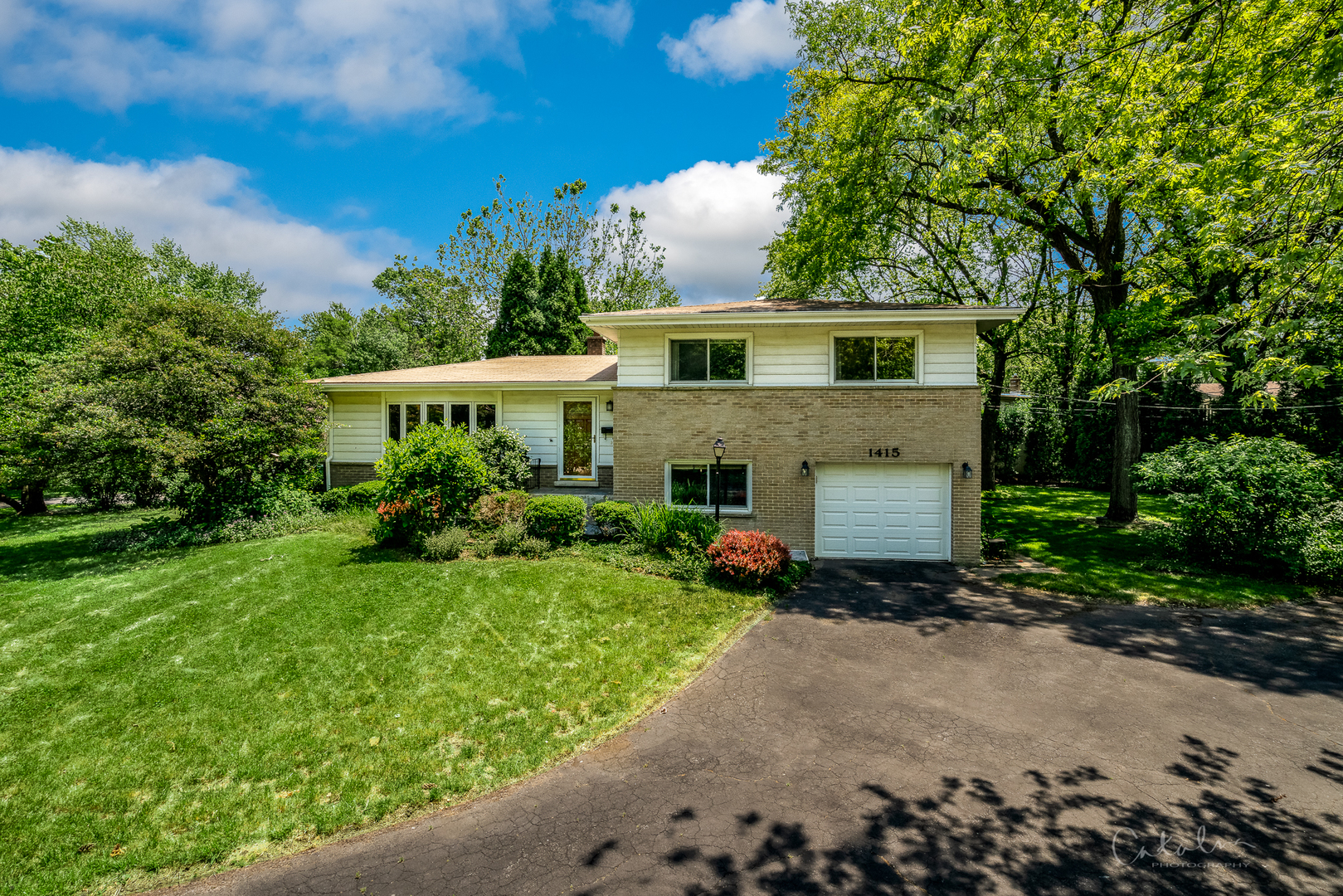 1415 Charing Cross Road Deerfield, IL 60015 - Photo 1 of 23 a front view of a house with a yard