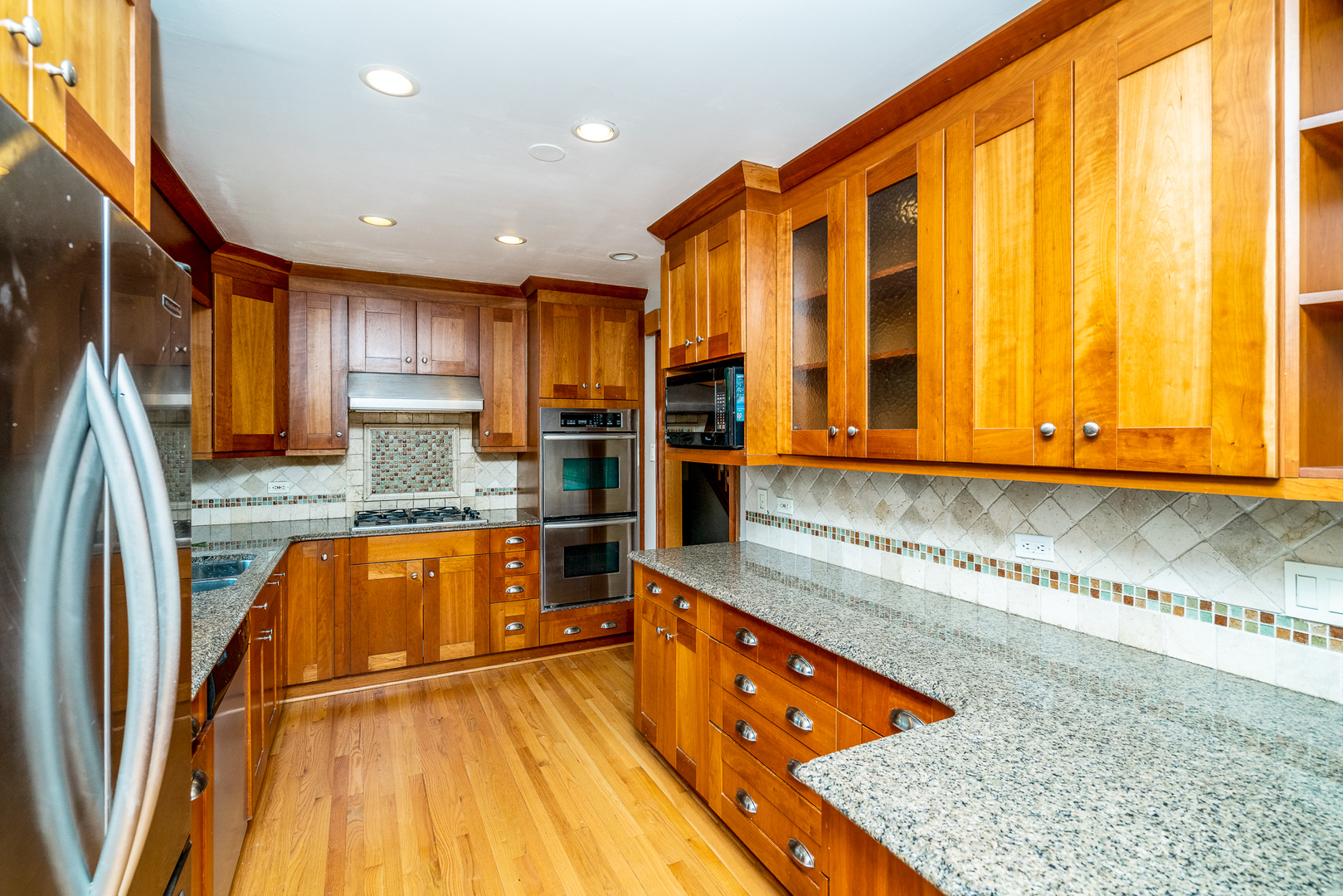 1415 Charing Cross Road Deerfield, IL 60015 - Photo 4 of 23 a kitchen with stainless steel appliances granite countertop a sink and a stove