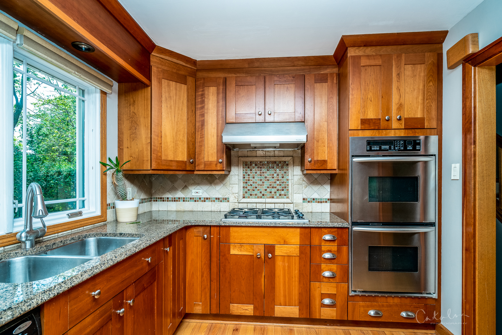 1415 Charing Cross Road Deerfield, IL 60015 - Photo 10 of 23 a kitchen with stainless steel appliances granite countertop a stove a sink and a microwave