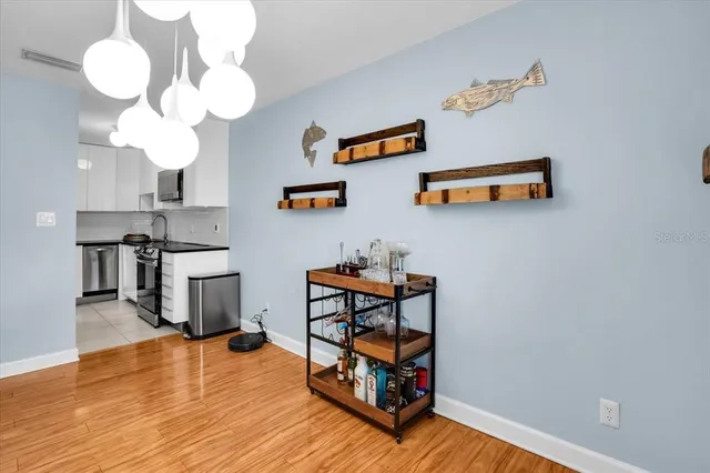 a view of a workspace with furniture and wooden floor