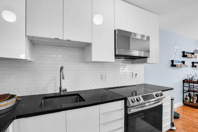 a kitchen with a sink and a stove top oven