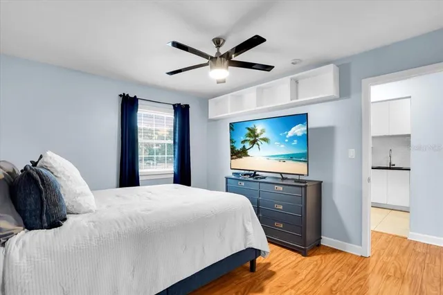 a bedroom with a bed and a flat screen tv