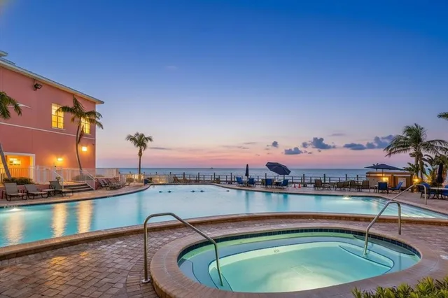 a small pool with couple of relaxing chair