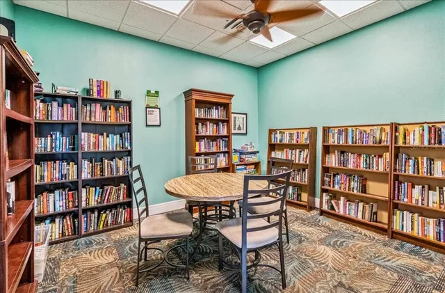 a view of a livingroom with furniture and a bookshelf
