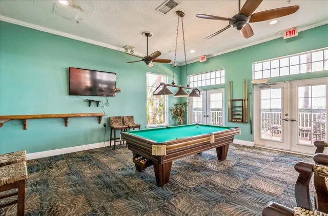 a room with pool tables and windows
