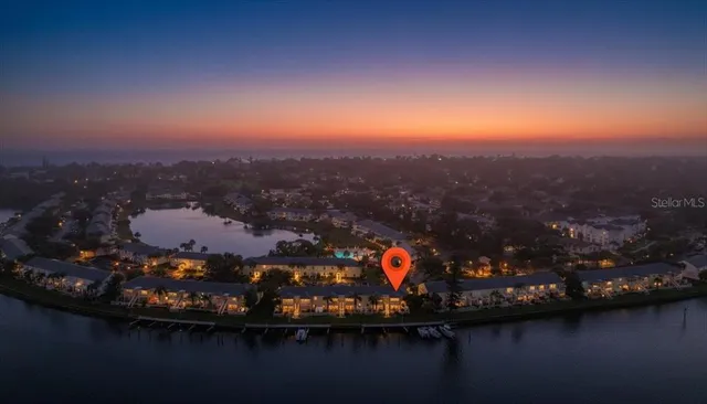 a view of a lake with lawn chairs