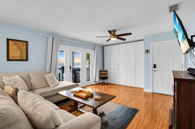 a living room with furniture and a wooden floor