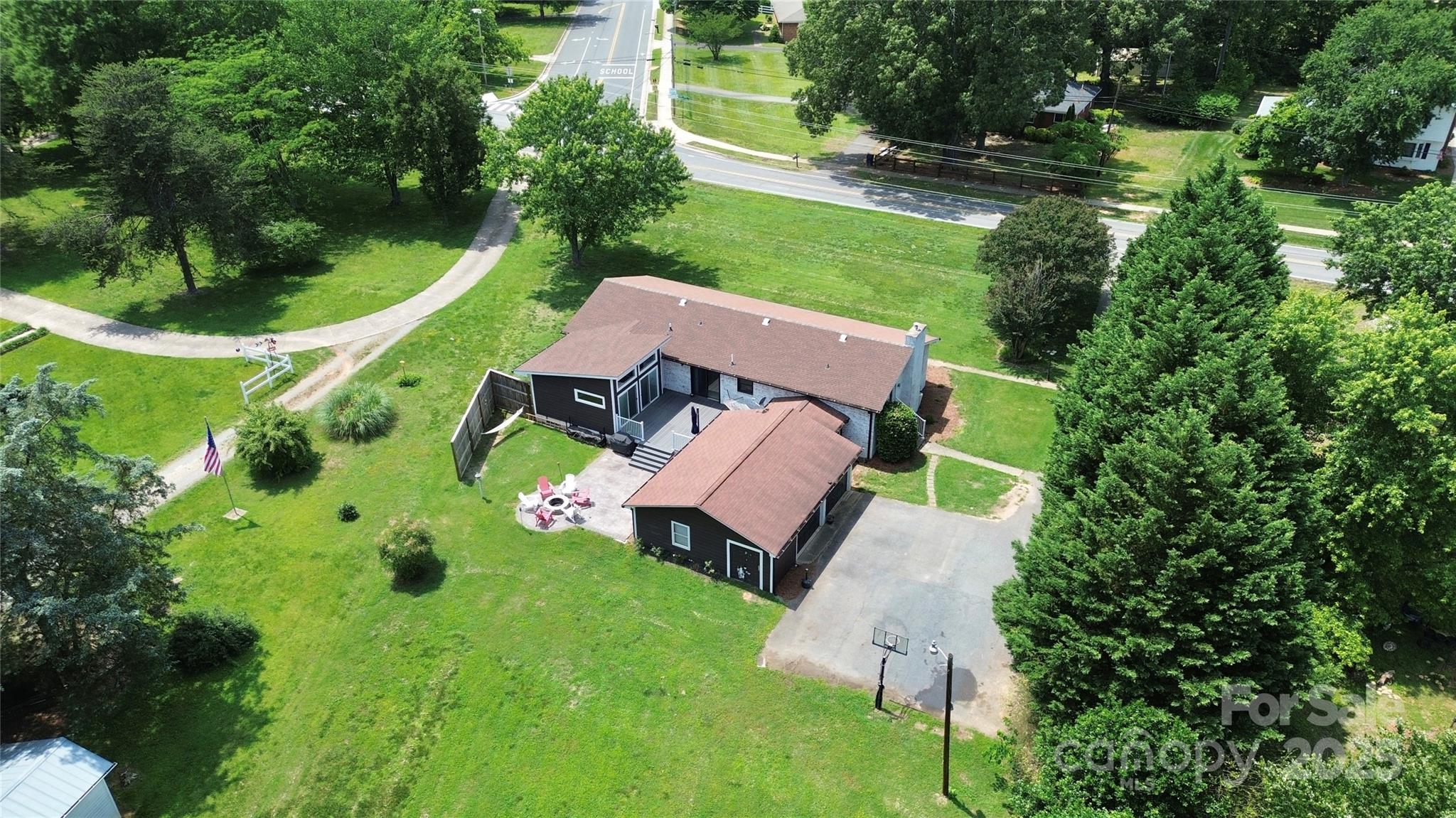 an aerial view of a house with garden space and street view