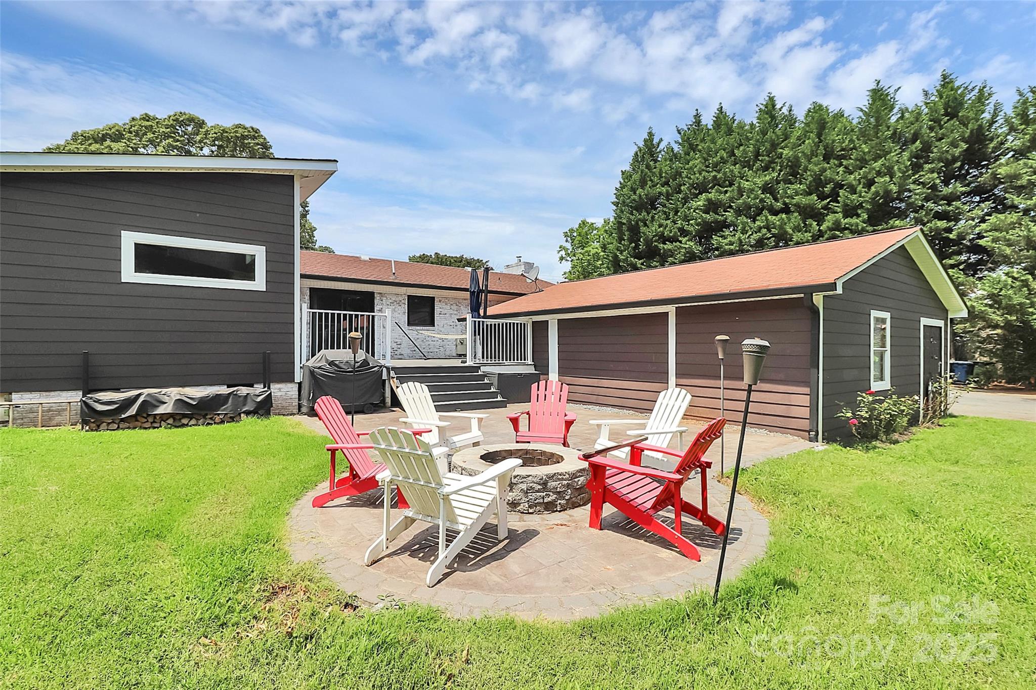 9808 Washam Potts Road Cornelius, NC 28031 - Photo 2 of 43 a view of a house with backyard sitting area and garden