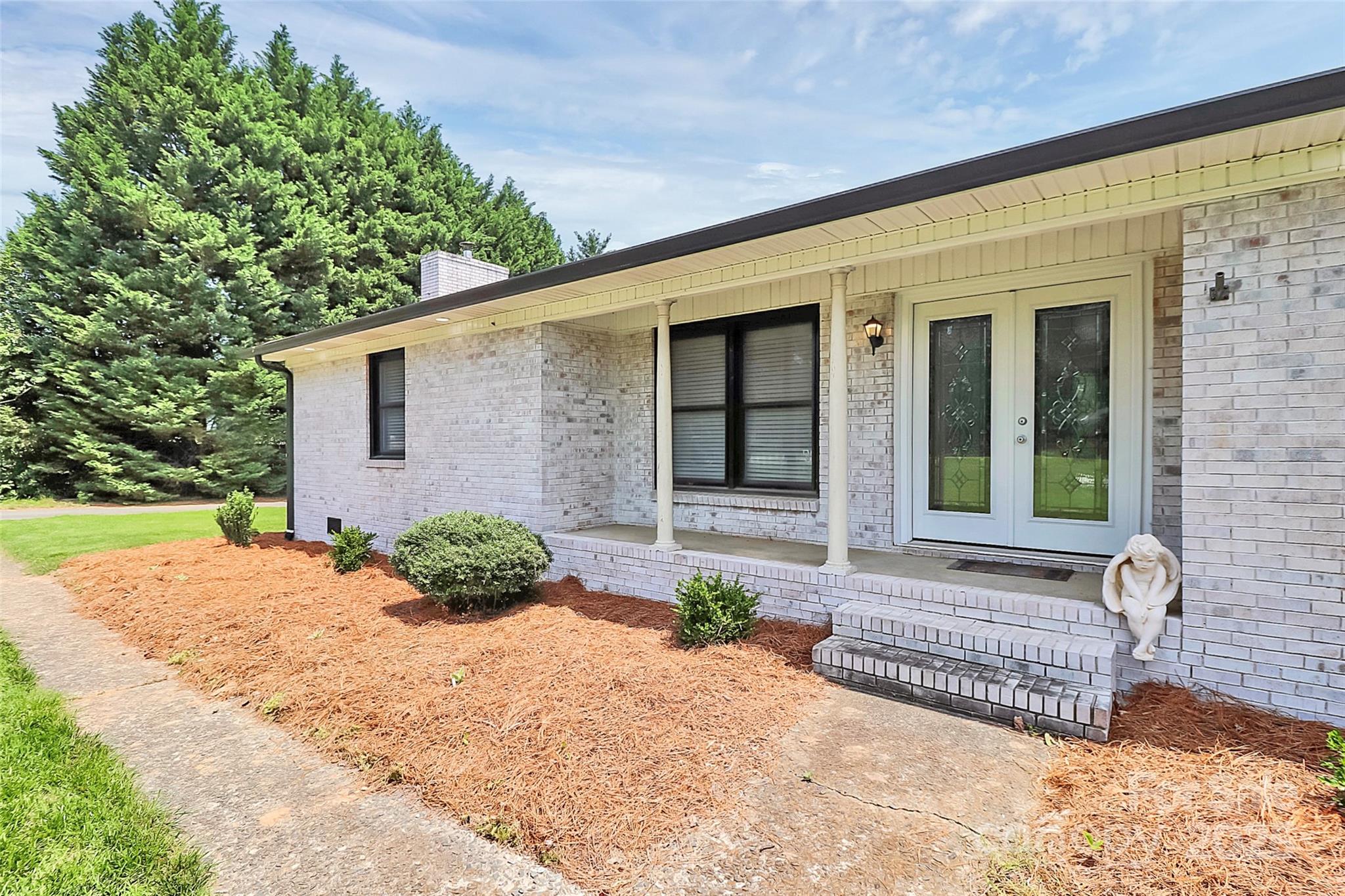 9808 Washam Potts Road Cornelius, NC 28031 - Photo 8 of 43 a front view of a house with a yard and garage