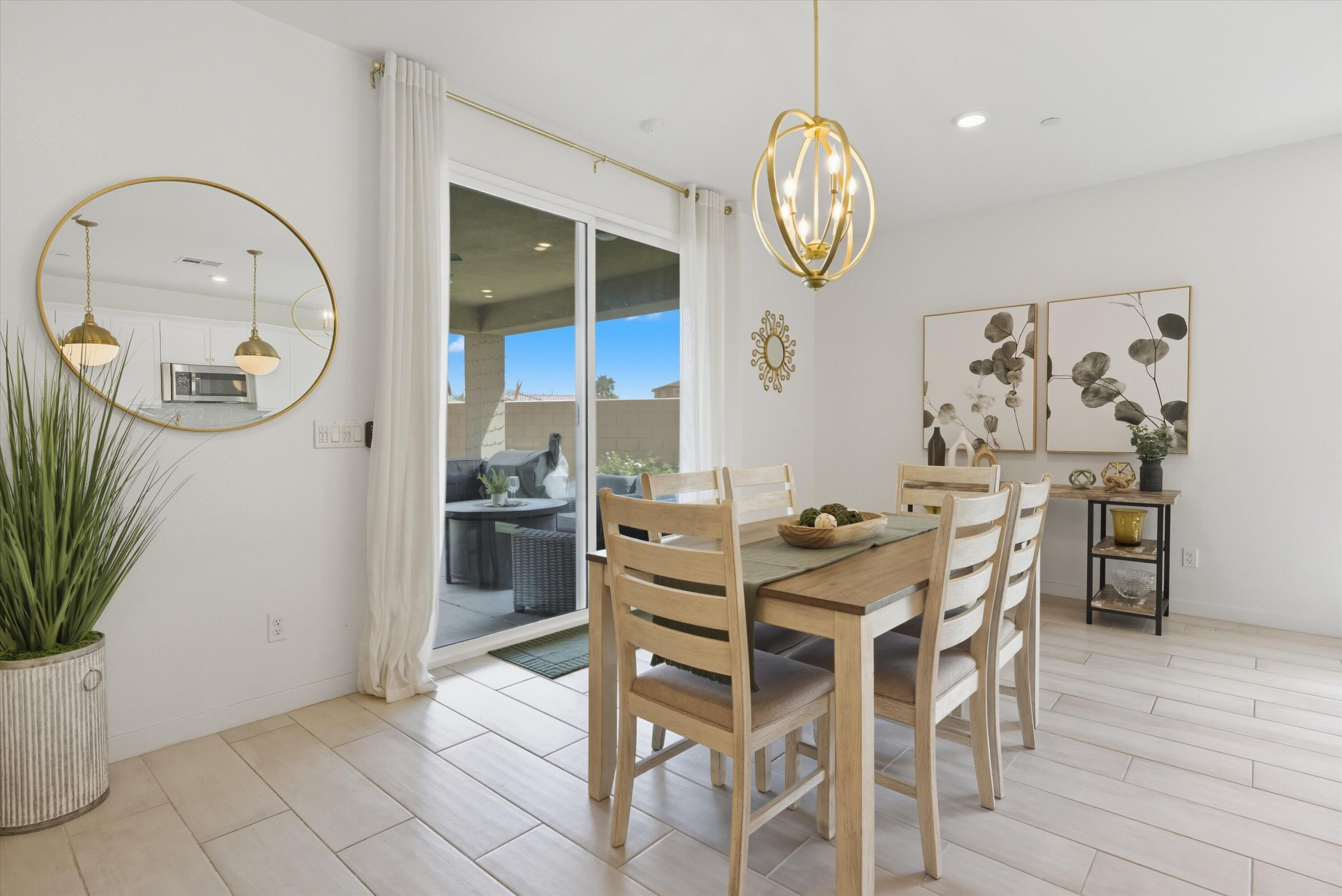 40340 Vivaldi Court Indio, CA 92203 - Photo 12 of 30 a view of a dining area with furniture and wooden floor
