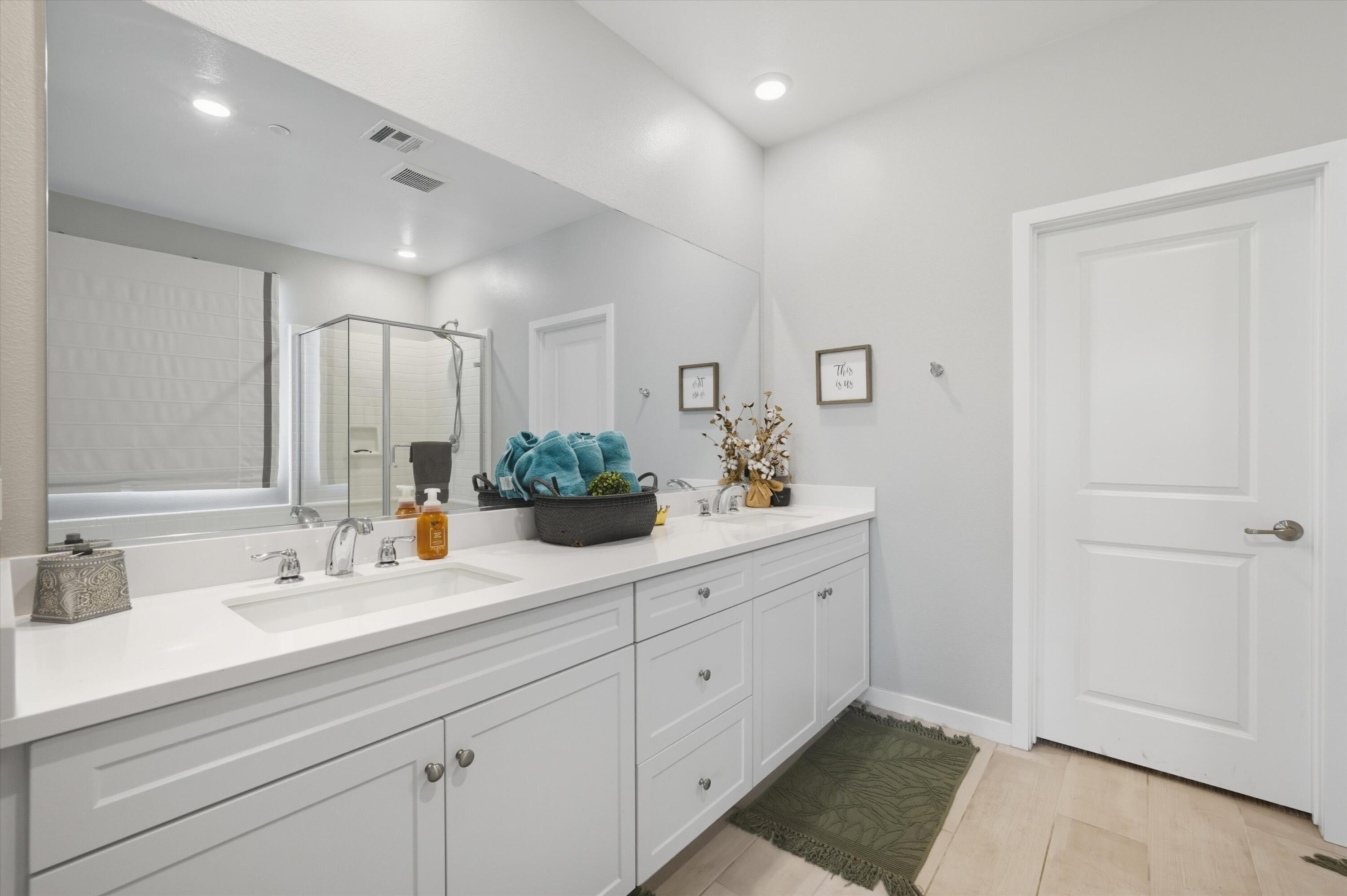 40340 Vivaldi Court Indio, CA 92203 - Photo 18 of 30 a spacious bathroom with double sink and a mirror