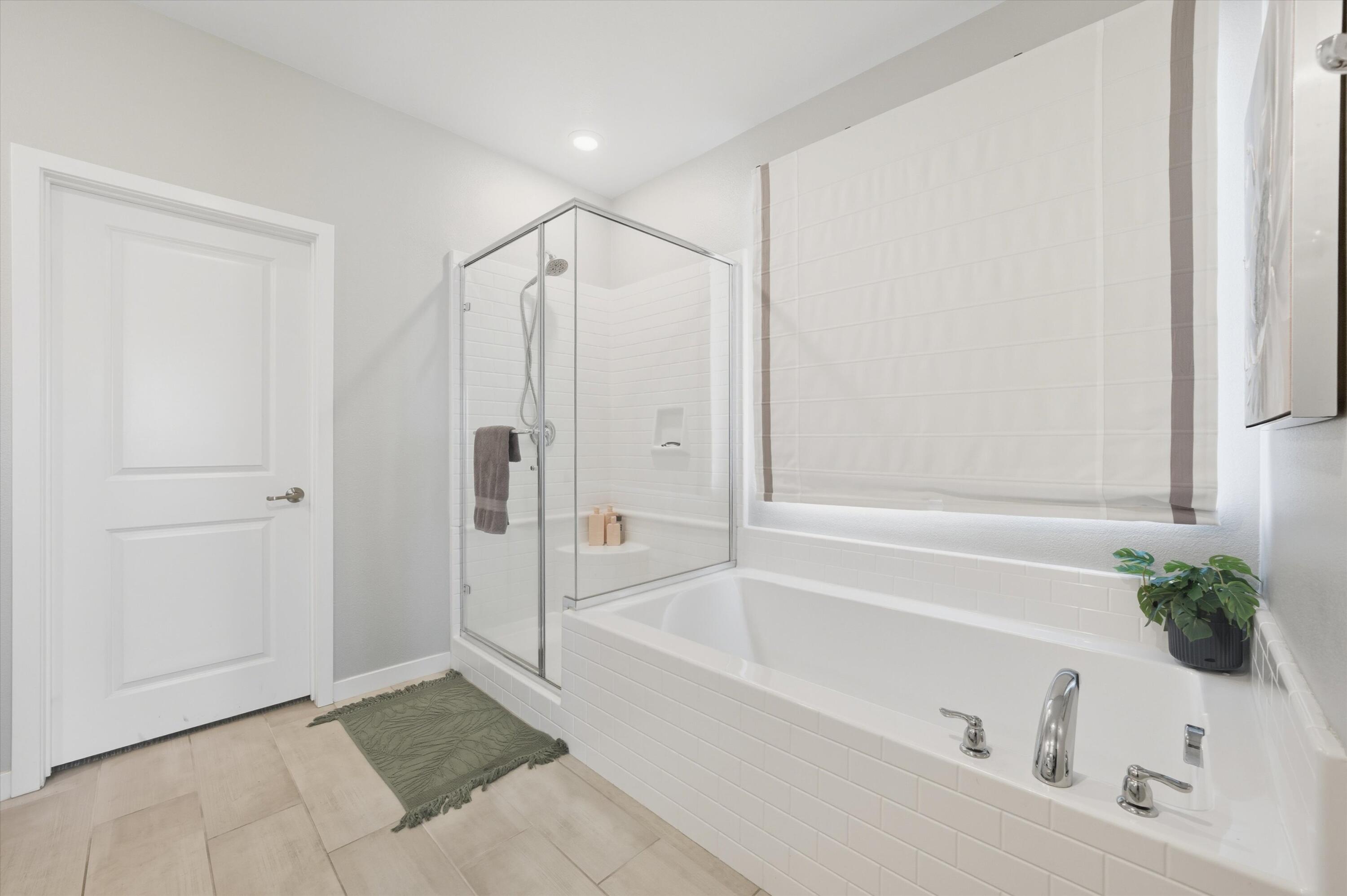 40340 Vivaldi Court Indio, CA 92203 - Photo 19 of 30 a bathroom with a bathtub and a shower