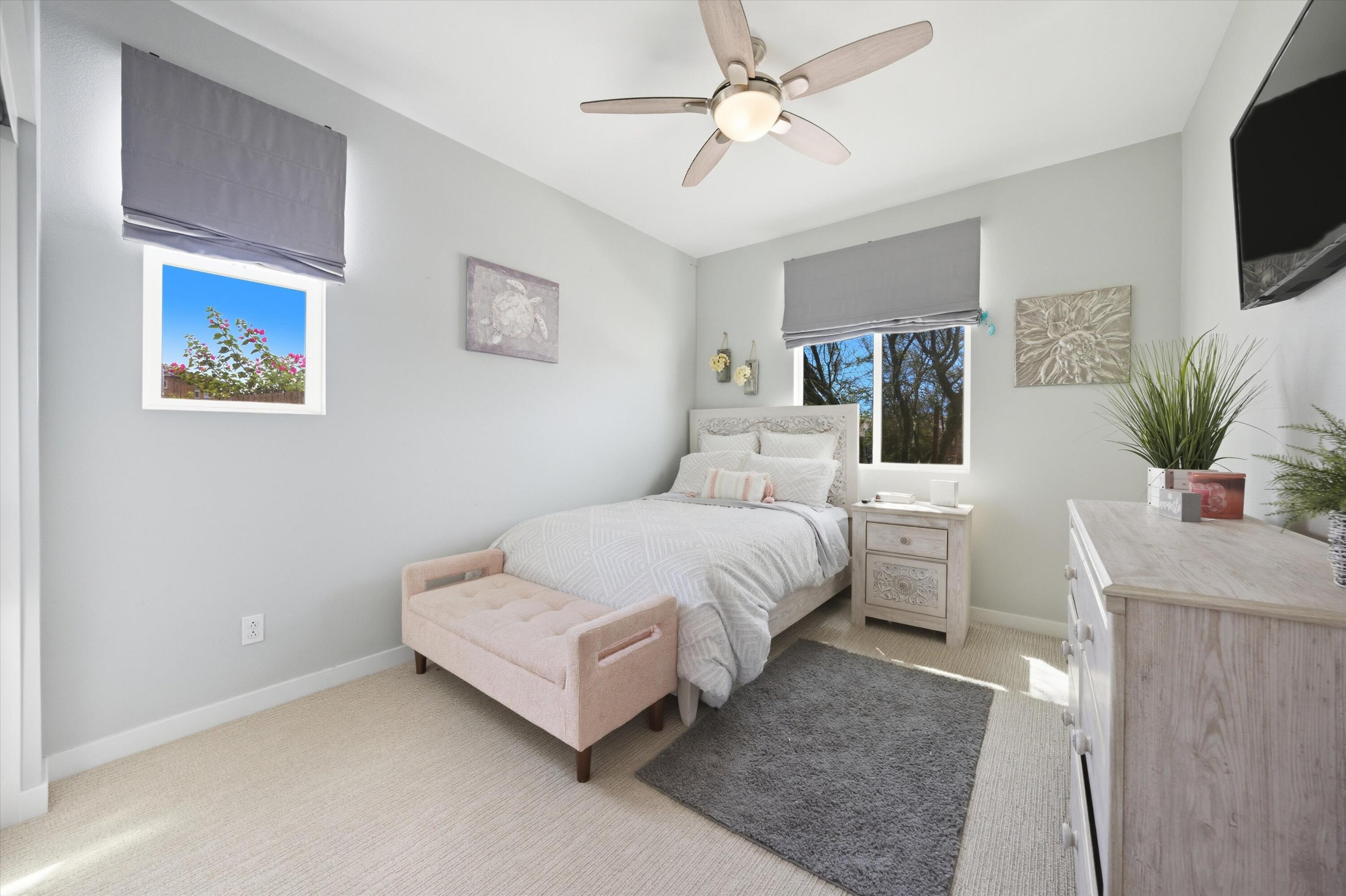 40340 Vivaldi Court Indio, CA 92203 - Photo 21 of 30 a bedroom with a bed a mirror on the wall and a flat screen tv