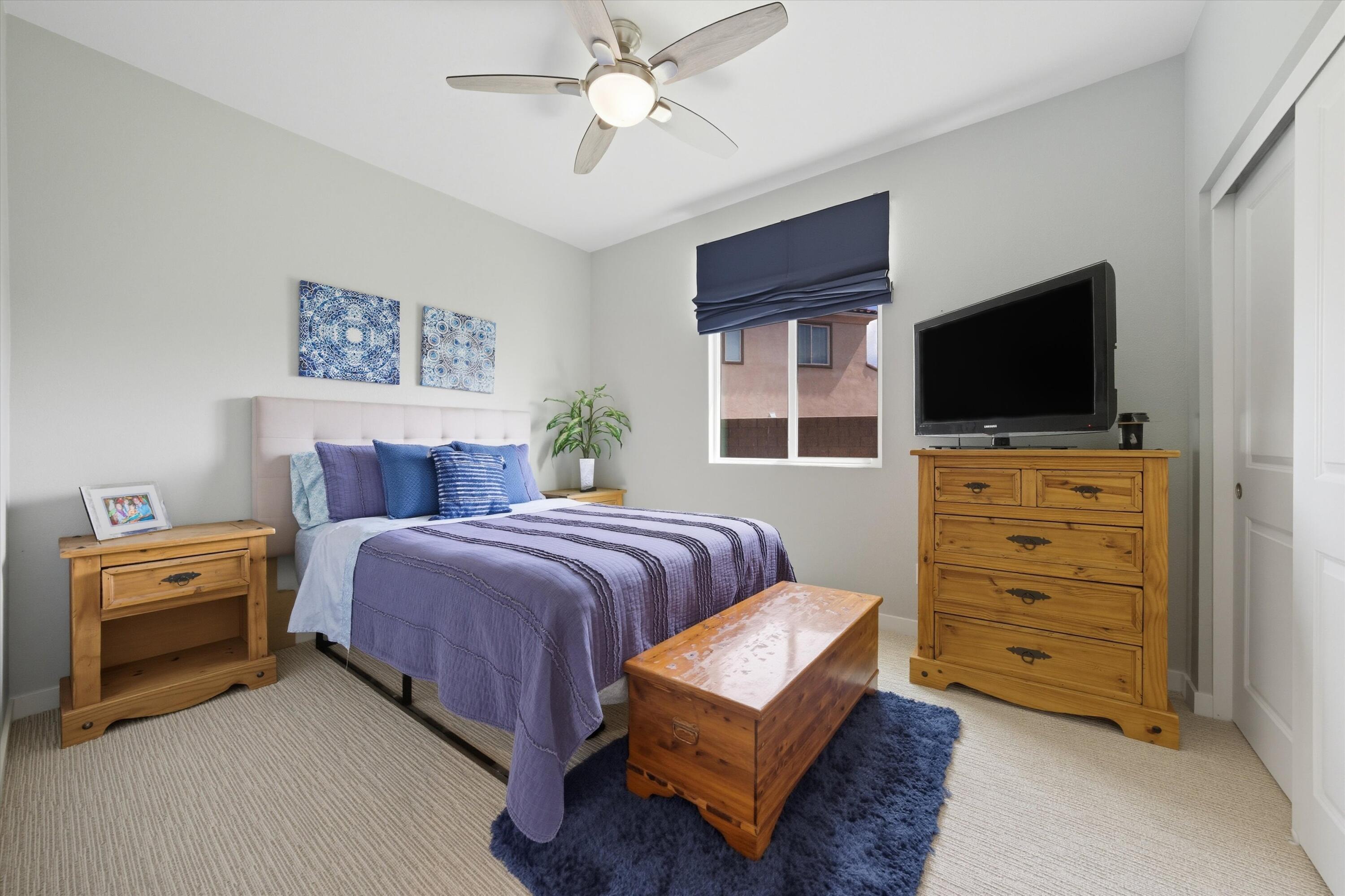 40340 Vivaldi Court Indio, CA 92203 - Photo 23 of 30 a bedroom with a bed and a flat screen tv