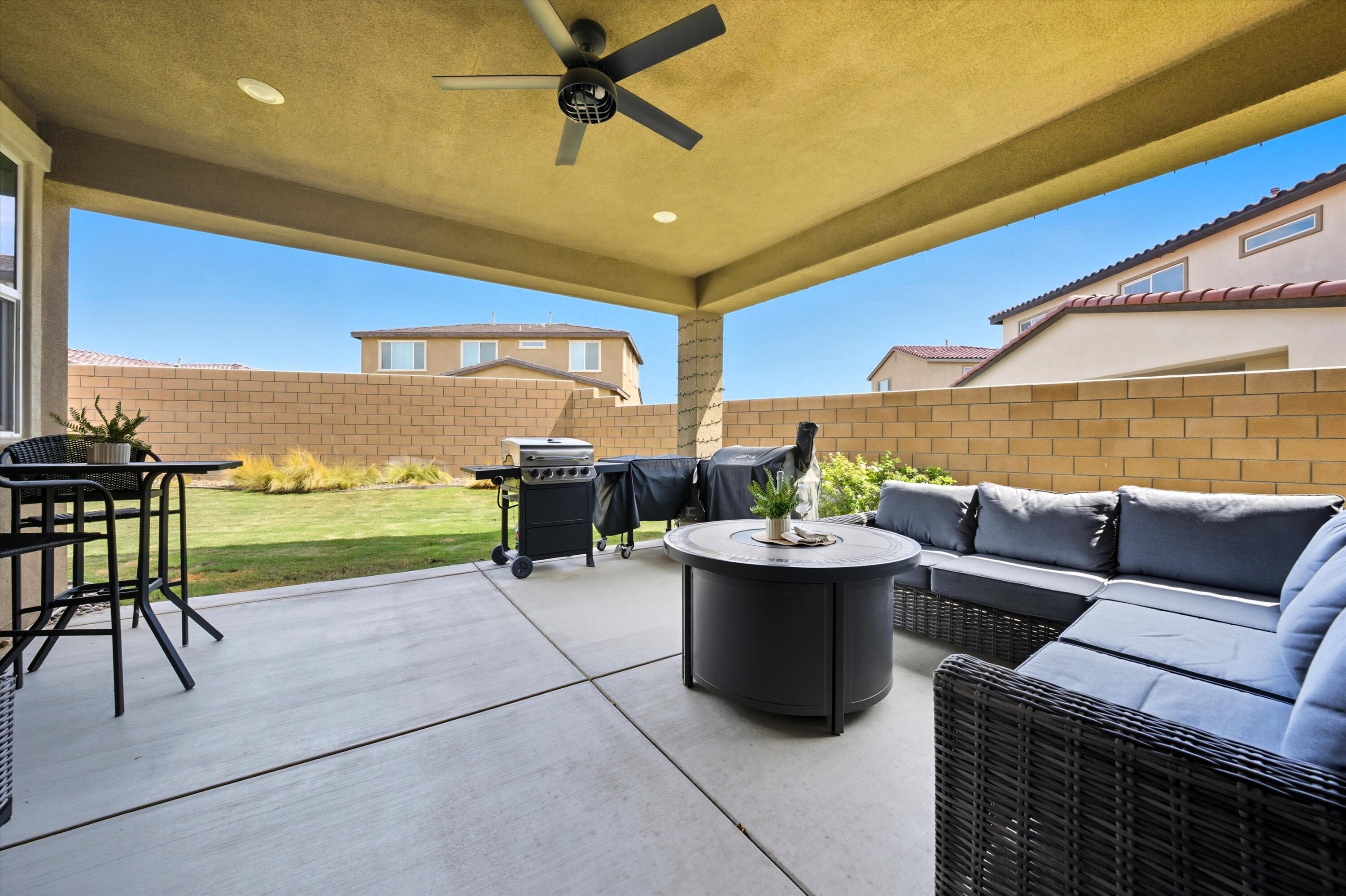 40340 Vivaldi Court Indio, CA 92203 - Photo 26 of 30 a living room with patio furniture and a floor to ceiling window