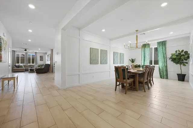 a large white kitchen with a large window and stainless steel appliances