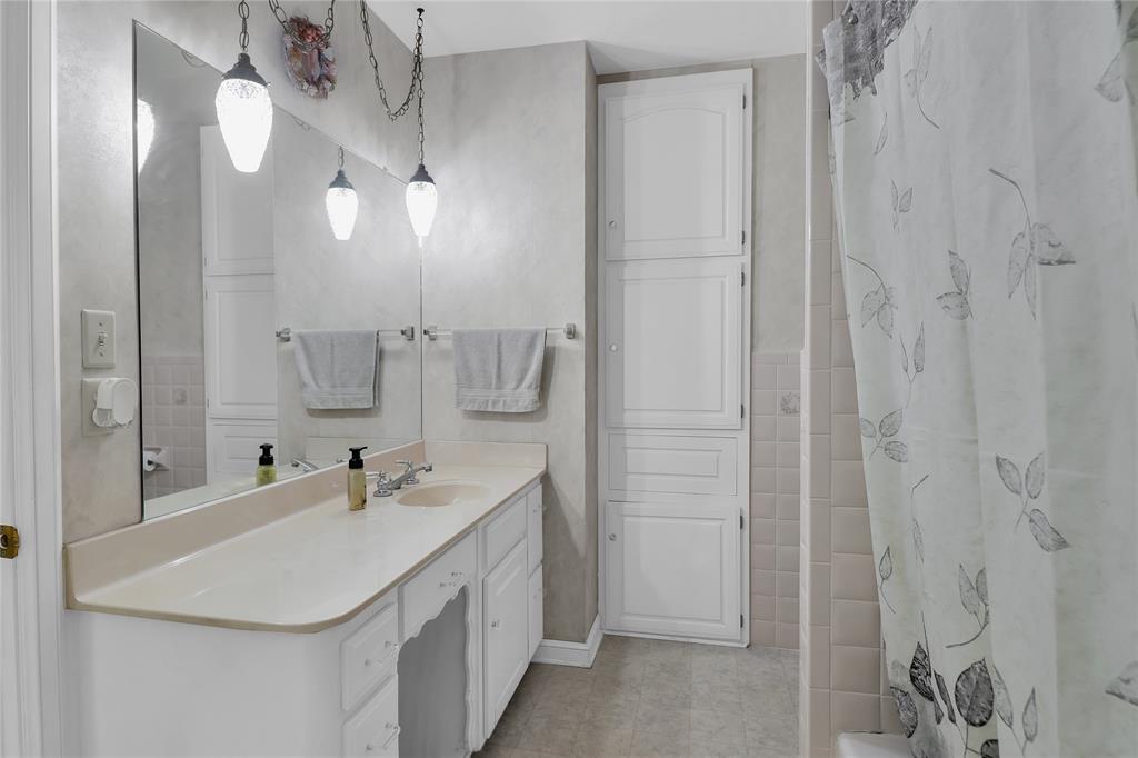 16223 Big Oak Bay Road Tyler, TX 75707 - Photo 23 of 30 Full bathroom featuring vanity, tile walls, and shower / bath combo