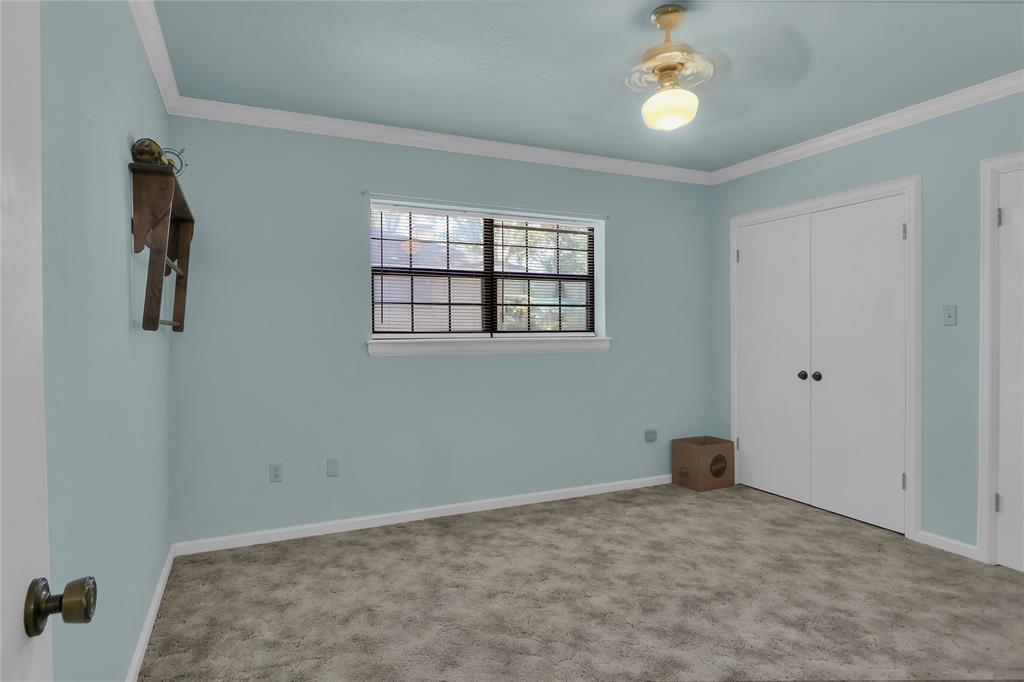 16223 Big Oak Bay Road Tyler, TX 75707 - Photo 25 of 30 Unfurnished bedroom with ornamental molding, ceiling fan, a closet, and carpet flooring