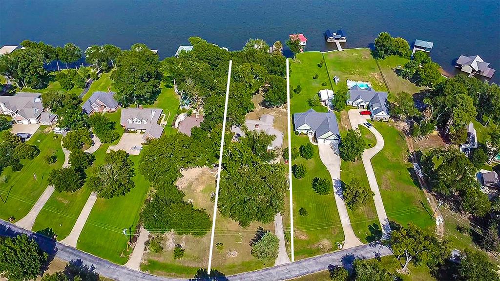 16223 Big Oak Bay Road Tyler, TX 75707 - Photo 4 of 30 Aerial view of residential area with property parcel outlined and a nearby body of water