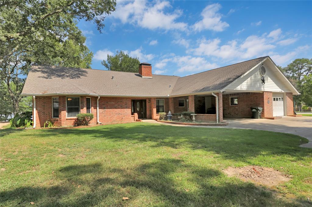 16223 Big Oak Bay Road Tyler, TX 75707 - Photo 7 of 30 View of front facade with concrete driveway, a front lawn, brick siding, and roof with shingles