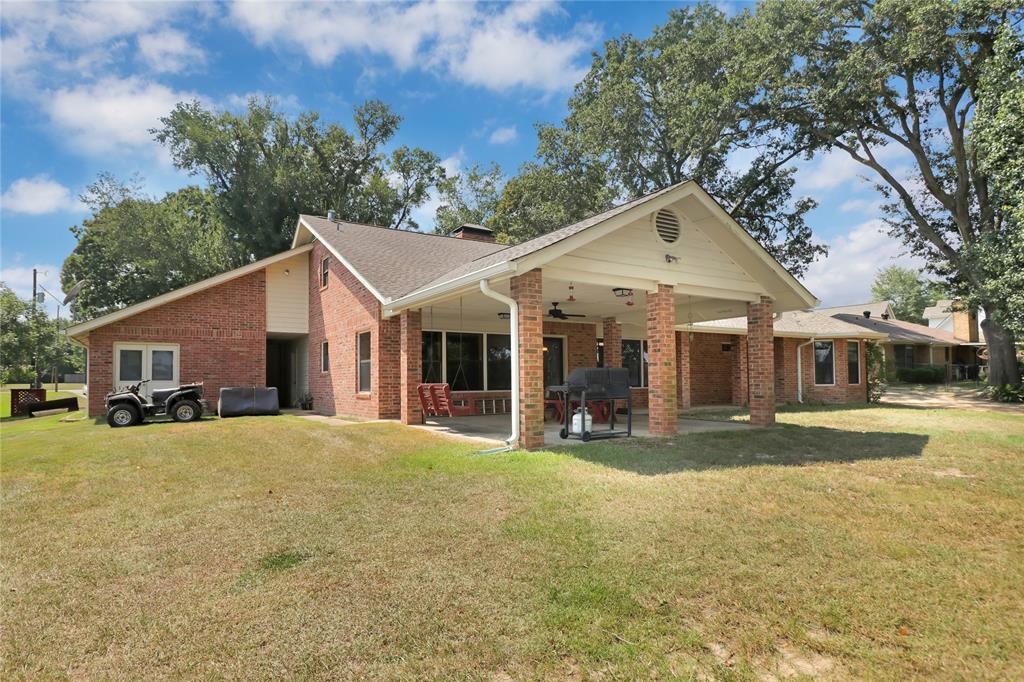 16223 Big Oak Bay Road Tyler, TX 75707 - Photo 10 of 30 Back of property with a lawn, brick siding, a patio, and a chimney
