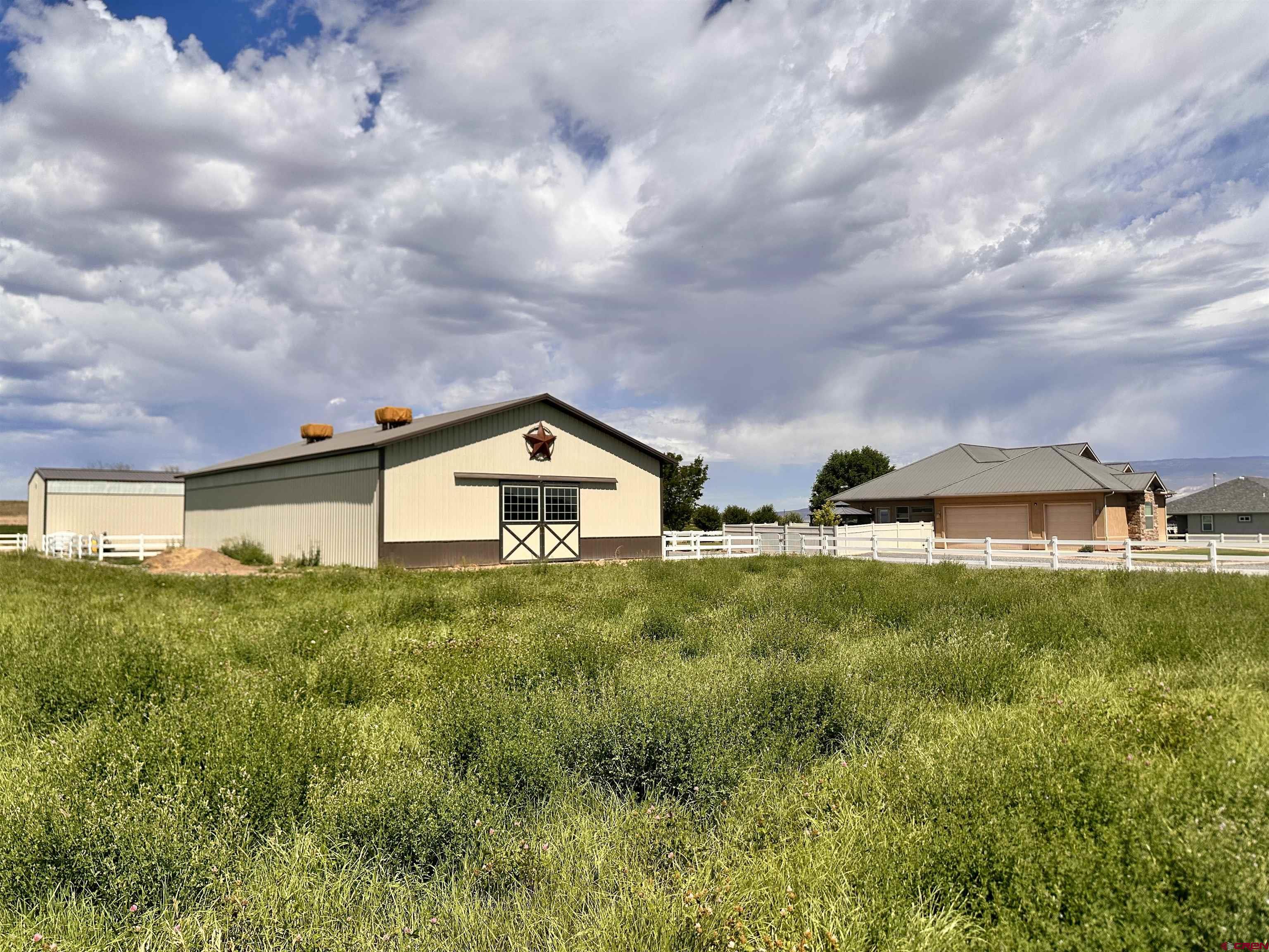 1889 Snaffle Bit Road Delta, CO 81416 - Photo 2 of 45 a front view of house with yard and trees