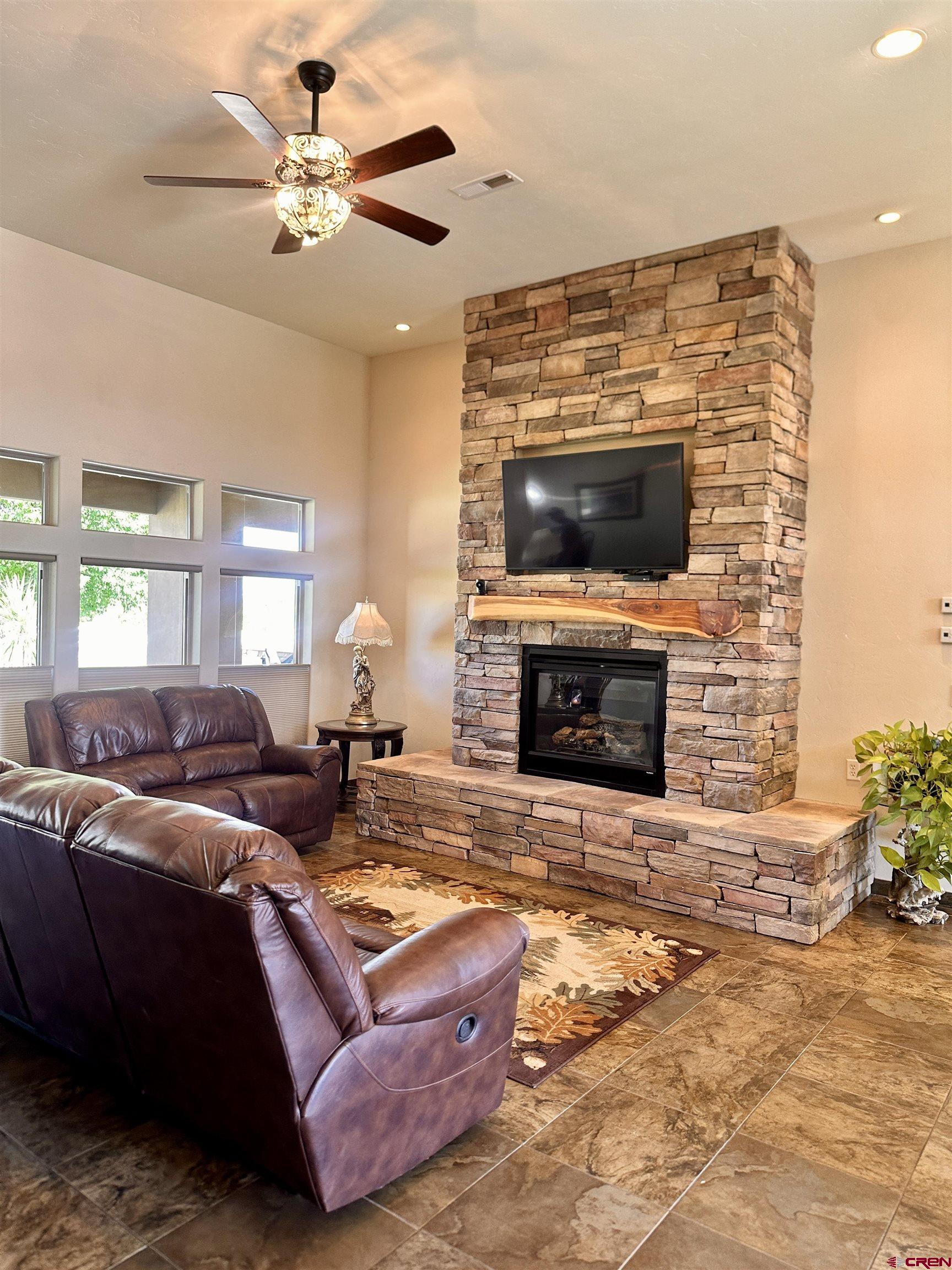 1889 Snaffle Bit Road Delta, CO 81416 - Photo 3 of 45 a living room with furniture a fireplace and a flat screen tv